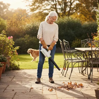 A person easily clearing leaves from a patio with a cordless leaf blower